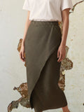 Celeni dark green pleated polyester asymmetric midi skirt with elastic waist.